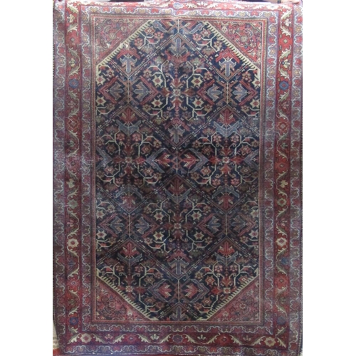 2410 - Interesting Persian village rug with repeating geometric medallion and floral decoration upon a navy... 