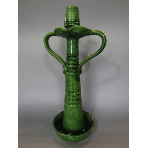 720 - A large green glazed two handled candlestick in the arts and crafts style, 39cm tall approx, togethe... 