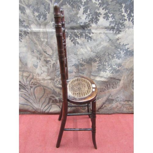 2081 - A regency beechwood child's correction chair, with simulated bamboo mouldings and oval cane panelled... 