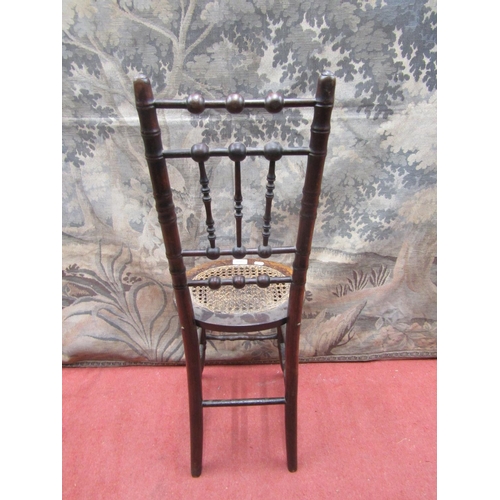 2081 - A regency beechwood child's correction chair, with simulated bamboo mouldings and oval cane panelled... 