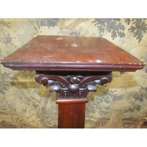 2087 - A late 19th century mahogany torchere, the pillar of square cut tapering form, beneath an ionic capi... 