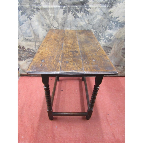 2091 - A Georgian oak side/occasional table, the overhanging rectangular planked top raised on four turned ... 
