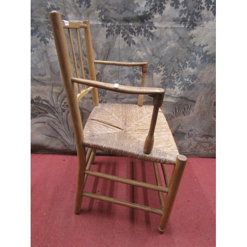 2119 - A 19th century ashwood elbow chair with turned mouldings and rush seat