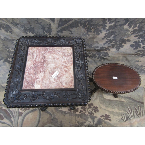 2165 - A good Chinese hardwood stand of oval form raised on scrolled toes with carved and pierced borders, ... 