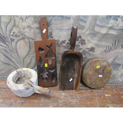 2197 - An antique timber shovel, a mortar in timber, a further primitive board and a pastry mould detailing... 