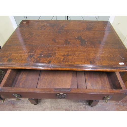 2090 - A good quality oak side table in the 17th century manner, the plank top with moulded outline over a ... 