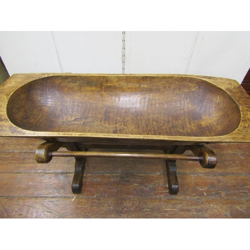2117 - An antique dugout trough of rectangular form, probably in birchwood, raised on an oak cradle, the pe... 
