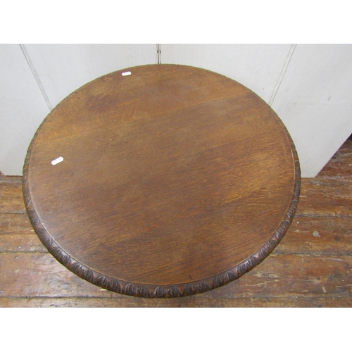 2141 - A mid Victorian period oak occasional table, the circular top 65cm diameter, raised on a tri-corn co... 