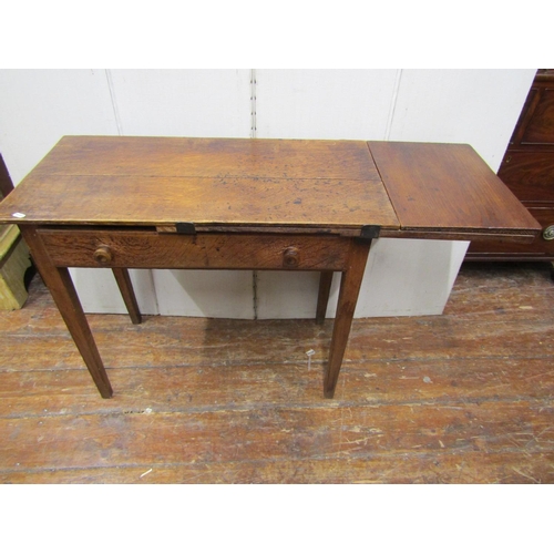 2146 - A rustic oak side table with single drop-leaf, enclosing a frieze drawer, raised on four square tape... 