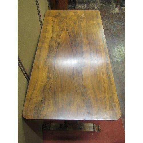 2154 - An early Victorian rosewood centre table of rectangular form, raised on a stretcher base with scroll... 