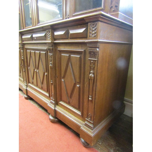 2156 - A substantial 19th century oak bookcase, the lower section enclosed by three panelled doors and thre... 