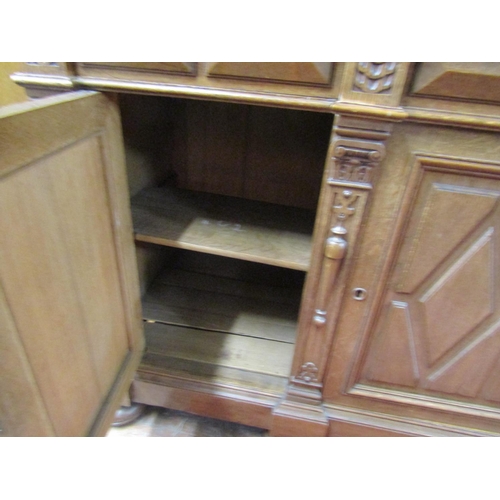 2156 - A substantial 19th century oak bookcase, the lower section enclosed by three panelled doors and thre... 