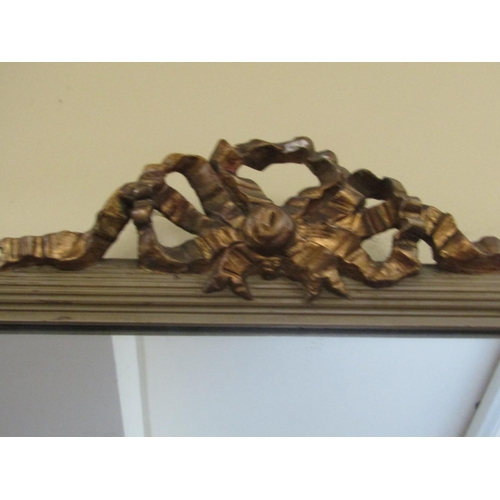 2158 - A large wall mirror of rectangular form, the reeded painted frame with gilded highlights, ribboned a... 