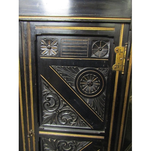 2180 - A small aesthetic movement side cabinet, the central lower section enclosed by two carved and panell... 