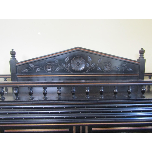 2180 - A small aesthetic movement side cabinet, the central lower section enclosed by two carved and panell... 