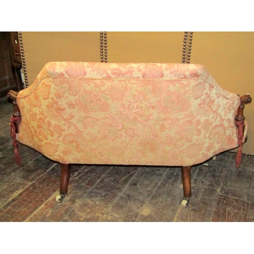 2188 - A Victorian drawing room sofa of small proportions, with carved walnut show wood frame, the shaped s... 