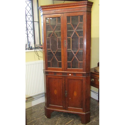 2199 - A Georgian oak freestanding corner cupboard, the lower section enclosed by two panelled doors, the u... 
