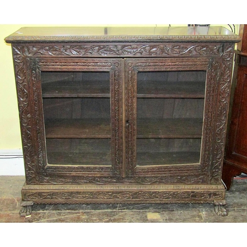 2200A - A 19th century side cupboard enclosed by a pair of glazed panelled doors, enclosing shelves, raised ... 
