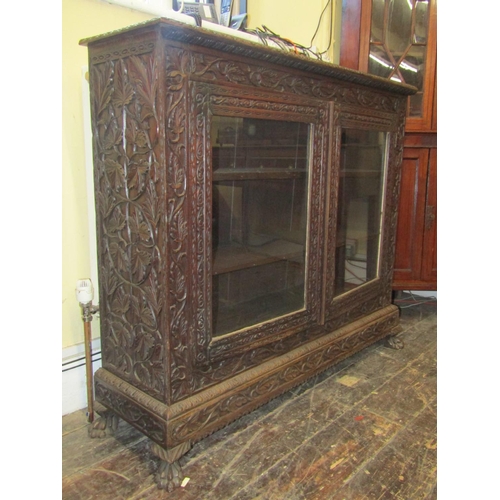 2200A - A 19th century side cupboard enclosed by a pair of glazed panelled doors, enclosing shelves, raised ... 