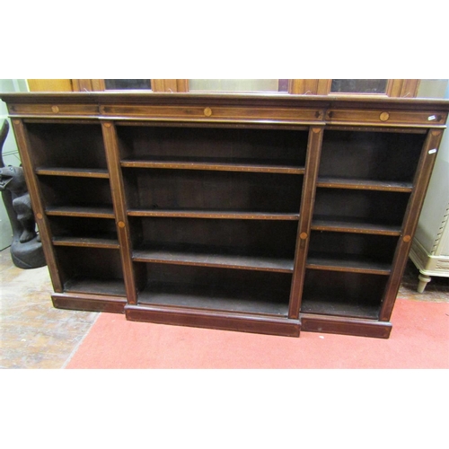 2200B - An Edwardian mahogany breakfront bookcase of narrow proportions enclosing an arrangement of adjustab... 