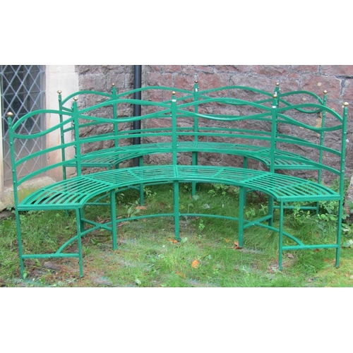 1675 - A pair of Regency style green painted light steel framed four seat sectional curved benches with str... 