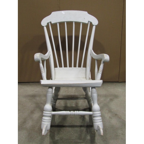 1860 - A Boston type child's stick-back rocking chair, with shaped arms, solid seat and turned supports, wi... 