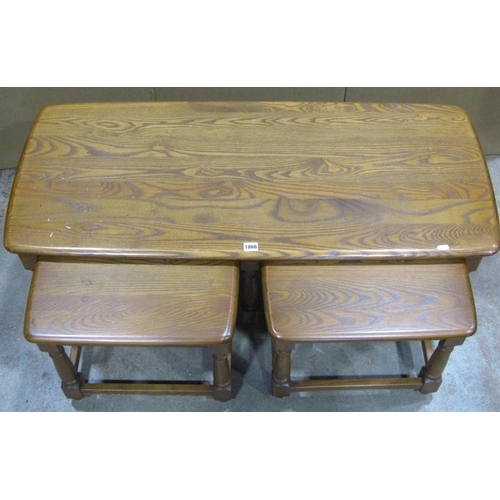 1866 - A nest of three Ercol medium elm occasional tables, the outer of rectangular form with moulded outli... 