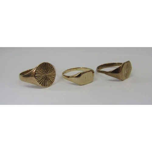 883 - Three 9ct rings; a bright cut example and two signets, 9.2g total (3)