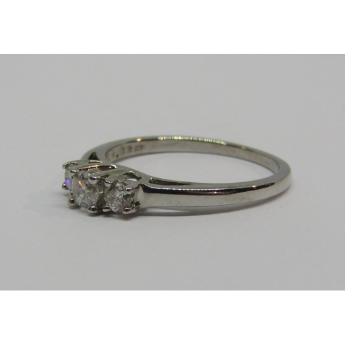 935 - 18ct white gold three stone diamond ring, in raised setting, size M, 2.5g