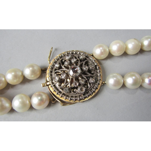 938 - Double strand pearl necklace with associated antique rose cut diamond set circular clasp, in unmarke... 