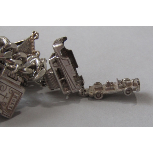 979 - Silver curb link charm bracelet with heart padlock clasp, hung with an interesting selection of most... 