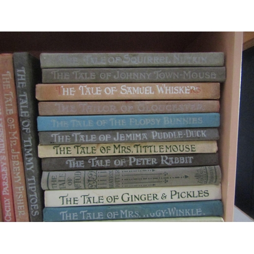 489 - Beatrix Potter - Twenty one volumes in a later Peter Rabbit bookshelf