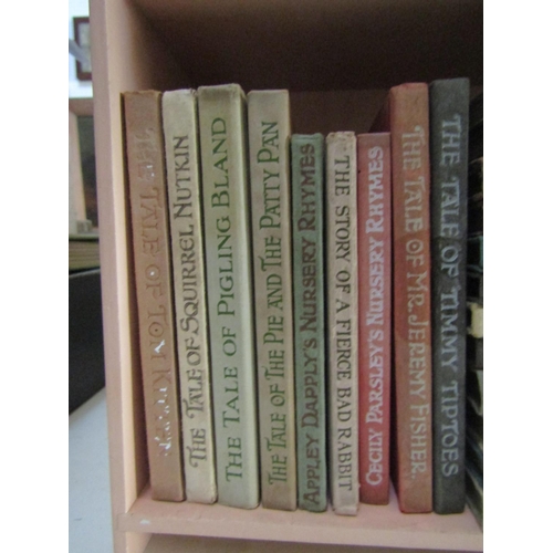 489 - Beatrix Potter - Twenty one volumes in a later Peter Rabbit bookshelf