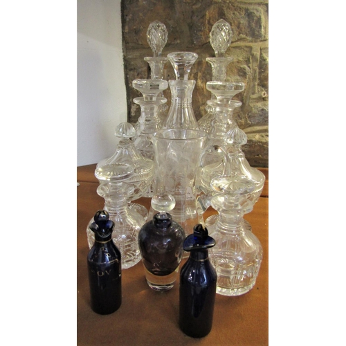 1153 - A mixed collection of glassware comprising three pairs of decanters, further decanter, pair of cup a... 