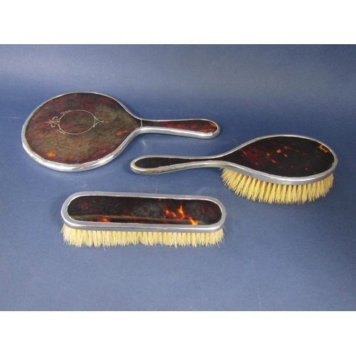 1267 - Matched three piece silver and tortoiseshell dressing set comprising mirror and two brushes (3)