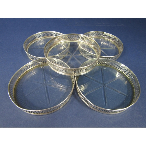 1269 - Five silver and star-cut glass coasters with raised gallery rims (5)