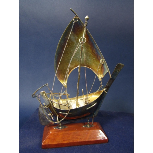 1281 - Cased white metal galleon with wooden plinth stand, 2 oz approx