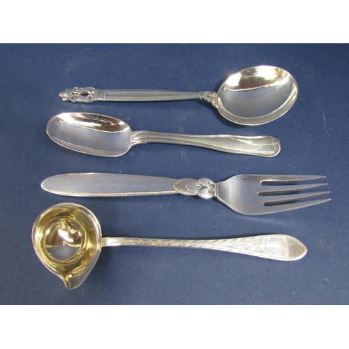 1287 - Three Danish Georg Jensen silver pieces of flatware comprising two spoons and a fork with stylised d... 