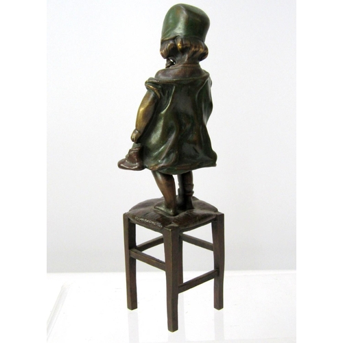 392 - Small bronze figure after Juan Clara of a child in a green dress, bound standing on a stool, one sho... 