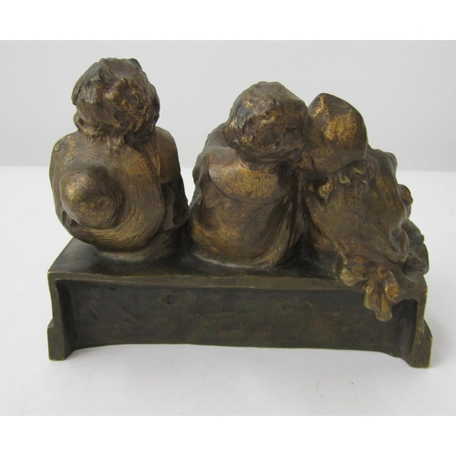 394 - Juan, Clara.  Cast bronze group of 3 amused and contented children sitting upon a bench. 15cm long