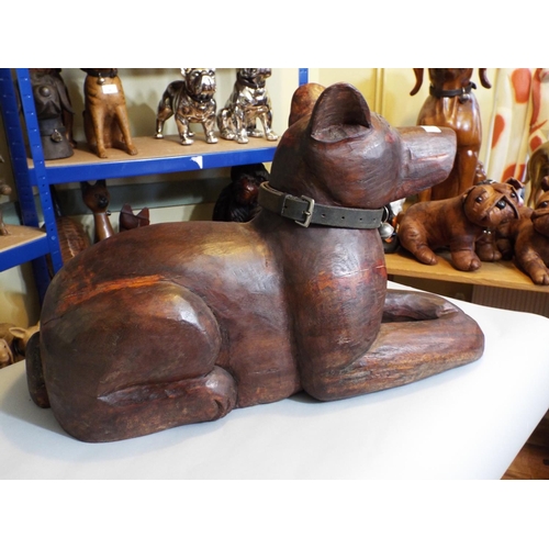 84 - A carved hardwood figure of a recumbent hound, 40cm max