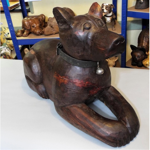 84 - A carved hardwood figure of a recumbent hound, 40cm max