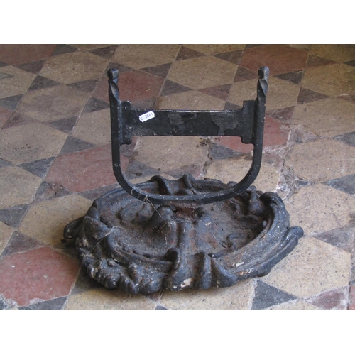 2104 - A cast iron boot scraper with oval scrolling acanthus tray