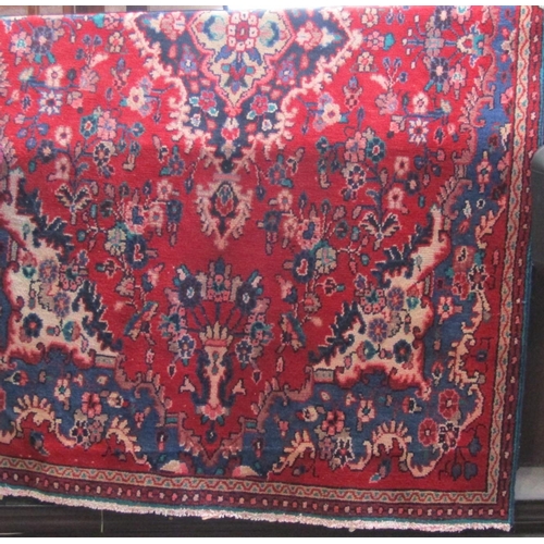 1797 - Persian rug with floral spray decoration in blue upon a red ground, 260 x 160cm