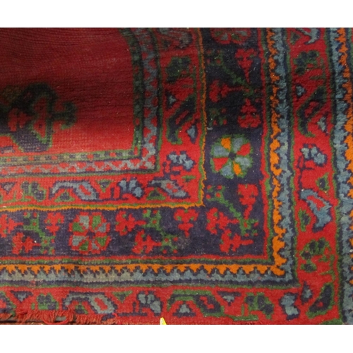 1803 - Turkish carpet with blue and green medallions upon a red ground, 320 x 250cm