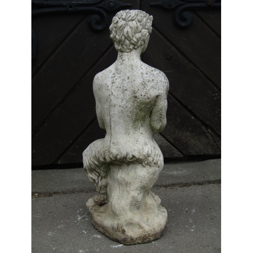 2079 - A partially weathered contemporary cast composition stone garden figure of pan in seated pose and cl... 