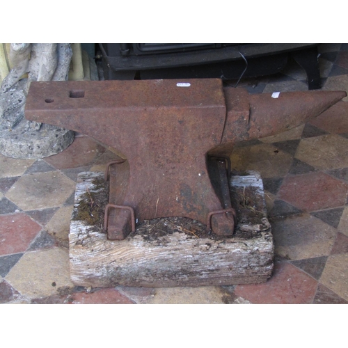 2086 - A small but heavy cast iron anvil mounted/pegged to an old wooden rectangular block (stamped), 59 cm... 