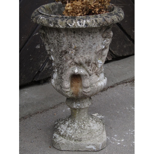 2091 - A small weathered Georgian style cast composition stone campana shaped garden urn with flared rim an... 