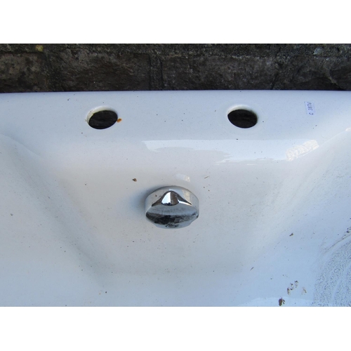 2072c - A cast iron and enamel roll top bath with central tap fixings approx 175 cm long x 82 cm wide