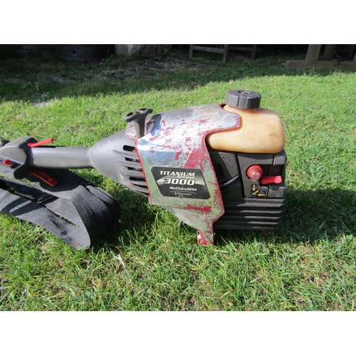 2112a - A Mcculloch titanium 3000 petrol driven strimmer, (AF), has compression (AF)